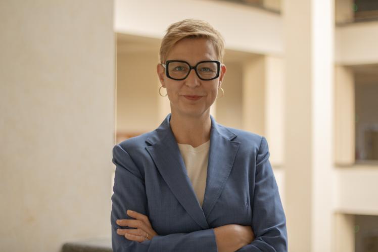 Woman wearing glasses with arms folded